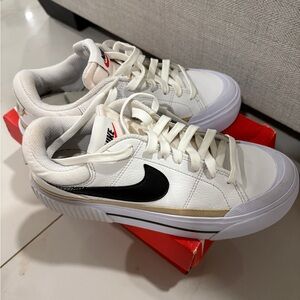 Nike Men's White and Black Sneakers with Gold Accent